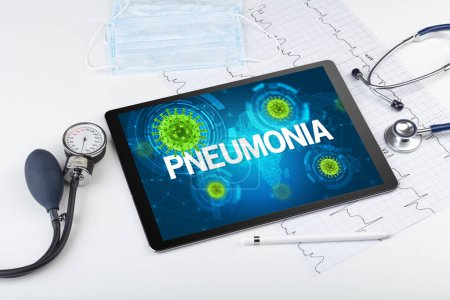 Foto de Vista de cerca de una tableta PC con inscripción PNEUMONIA, concepto de microbiología - Imagen libre de derechos
