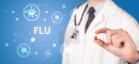 Photo for Doctor giving pill with FLU inscription, coronavirus concept - Royalty Free Image