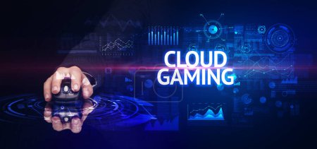 Photo for Hand holding wireless peripheral with CLOUD GAMING inscription, modern technology concept - Royalty Free Image