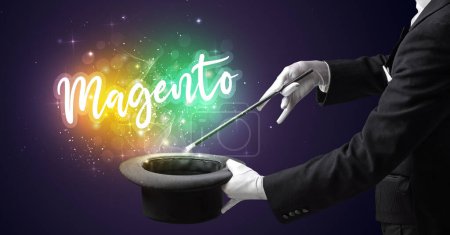 Photo for Magician hand conjure with wand and Magento inscription, shopping concept - Royalty Free Image