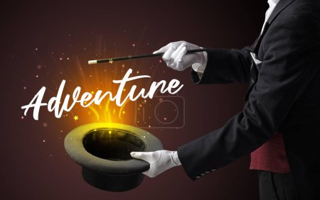 Photo for Magician is showing magic trick with Adventure inscription, traveling concept - Royalty Free Image