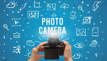 Photo for Hand taking picture with digital camera and PHOTO CAMERA inscription, camera settings concept - Royalty Free Image