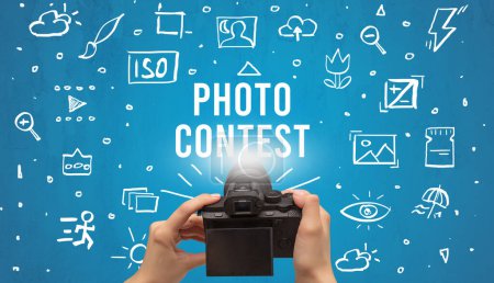 Photo for Hand taking picture with digital camera and PHOTO CONTEST inscription, camera settings concept - Royalty Free Image