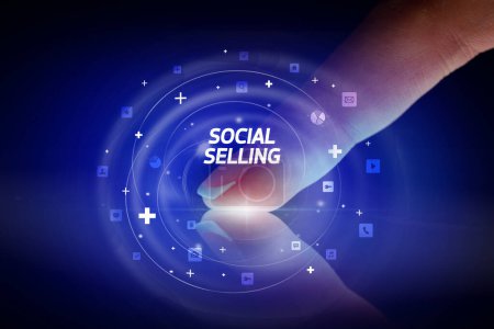 Photo for Finger touching tablet with social media icons and SOCIAL SELLING - Royalty Free Image