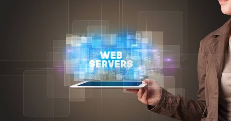 Photo for Young business person working on tablet and shows the inscription: WEB SERVERS - Royalty Free Image
