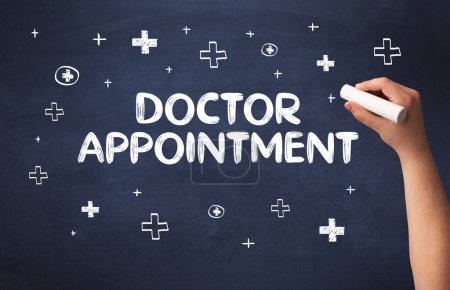 Photo for Hand drawing DOCTOR APPOINTMENT inscription with white chalk on blackboard, medical concept - Royalty Free Image