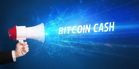 Photo for Young person shouting in loudspeaker with BITCOIN CASH inscription, business concept - Royalty Free Image