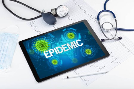 Photo for Close-up view of a tablet pc with EPIDEMIC inscription, microbiology concept - Royalty Free Image