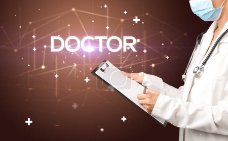 Photo for Doctor fills out medical record with DOCTOR inscription, medical concept - Royalty Free Image