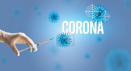 Photo for Close-up view of doctors hand in a white glove holding syringe with CORONA inscription, coronavirus antidote concept - Royalty Free Image