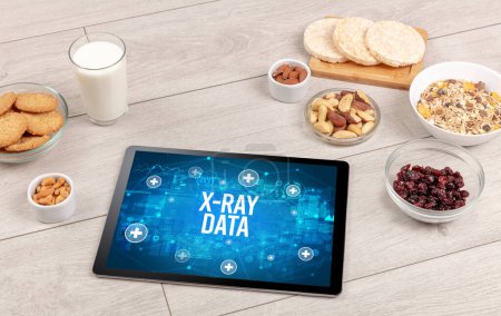 Foto de X-RAY DATA concept in tablet pc with healthy food around, top view - Imagen libre de derechos