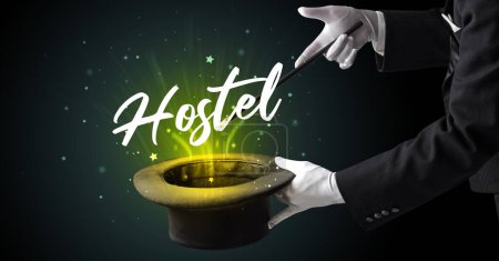 Photo for Magician is showing magic trick with Hostel inscription, traveling concept - Royalty Free Image