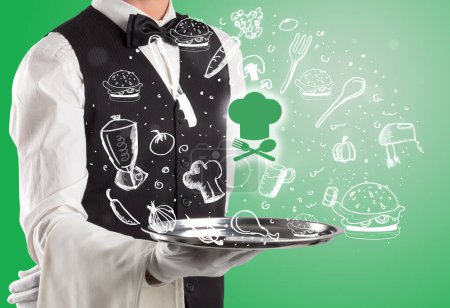 Foto de Camarero sosteniendo bandeja de plata con iconos de chef saliendo de ella, concepto de comida saludable - Imagen libre de derechos