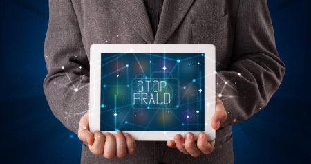 Photo for Young business person working on tablet and shows the digital sign: STOP FRAUD - Royalty Free Image
