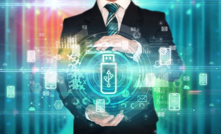 Foto de Empresario sosteniendo el icono del portador de datos en sus manos con múltiples símbolos de tecnología a su alrededor - Imagen libre de derechos