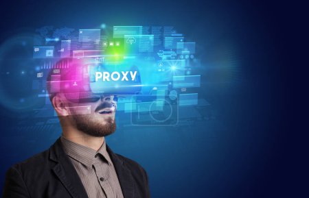 Photo for Businessman looking through Virtual Reality glasses with PROXY inscription, innovative security concept - Royalty Free Image