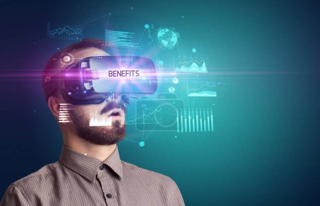Photo for Businessman looking through Virtual Reality glasses with BENEFITS inscription, new business concept - Royalty Free Image