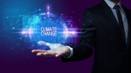 Photo for Man hand holding CLIMATE CHANGE inscription, technology concept - Royalty Free Image