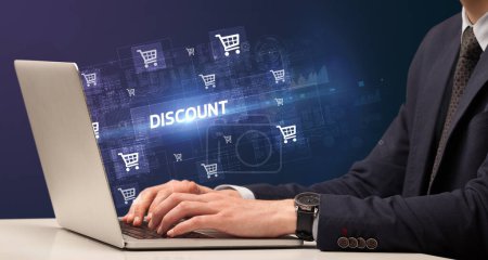 Photo for Businessman working on laptop with DISCOUNT inscription, online shopping concept - Royalty Free Image
