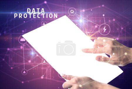 Photo for Holding futuristic tablet with DATA PROTECTION inscription, cyber security concept - Royalty Free Image