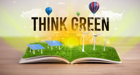 Foto de Libro abierto con inscripción THINK GREEN, concepto de energía renovable - Imagen libre de derechos