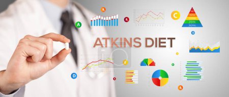 Photo for Nutritionist giving you a pill with ATKINS DIET inscription, healthy lifestyle concept - Royalty Free Image