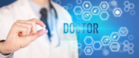 Photo for Close-up of a doctor giving you a pill with DOCTOR inscription, medical concept - Royalty Free Image
