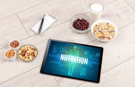 Téléchargez les photos : Concept NUTRITION en tablette avec fruits, vue du dessus - en image libre de droit