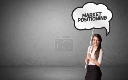 Photo for Young business person in casual holding road sign with MARKET POSITIONING inscription, new business idea concept - Royalty Free Image