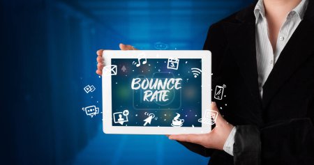 Photo for Young business person working on tablet and shows the inscription: BOUNCE RATE - Royalty Free Image