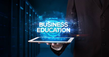 Photo for Young business person working on tablet and shows the inscription: BUSINESS EDUCATION, business concept - Royalty Free Image
