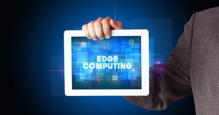 Photo for Young business person working on tablet and shows the inscription: EDGE COMPUTING - Royalty Free Image