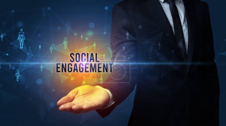 Photo for Elegant hand holding SOCIAL ENGAGEMENT inscription, social networking concept - Royalty Free Image