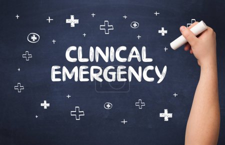 Photo for Hand drawing CLINICAL EMERGENCY inscription with white chalk on blackboard, medical concept - Royalty Free Image