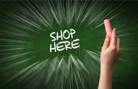 Photo for Hand drawing SHOP HERE inscription with white chalk on blackboard, online shopping concept - Royalty Free Image