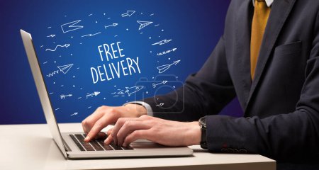 Photo for Businessman working on laptop with FREE DELIVERY inscription, online shopping concept - Royalty Free Image