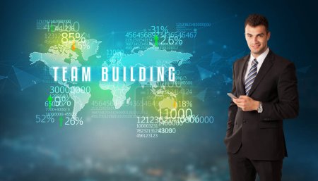 Téléchargez les photos : Homme d'affaires devant une décision avec inscription TEAM BUILDING, concept d'entreprise - en image libre de droit