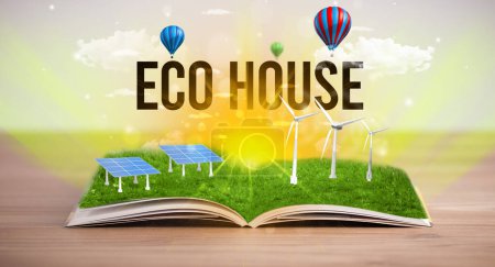 Photo for Open book with ECO HOUSE inscription, renewable energy concept - Royalty Free Image