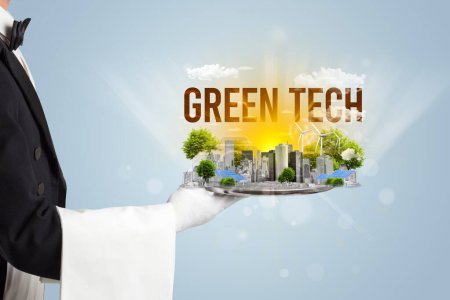 Photo for Waiter serving eco city with GREEN TECH inscription, renewabke energy concept - Royalty Free Image