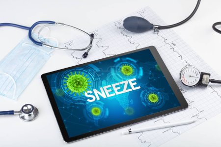 Photo for Close-up view of a tablet pc with SNEEZE inscription, microbiology concept - Royalty Free Image