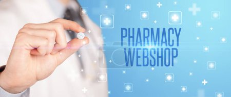 Photo for Close-up of a doctor giving a pill with PHARMACY WEBSHOP inscription, medical concept - Royalty Free Image
