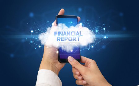 Female hand touching smartphone with FINANCIAL REPORT inscription, cloud business concept