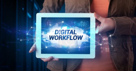 Photo for Young business person working on tablet and shows the inscription: DIGITAL WORKFLOW - Royalty Free Image