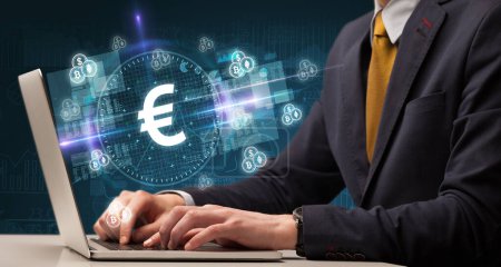 Photo for Business hand working in stock market with euro icons coming out from laptop screen - Royalty Free Image