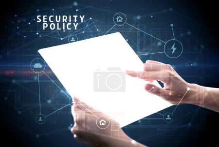 Holding futuristic tablet with SECURITY POLICY inscription, cyber security concept