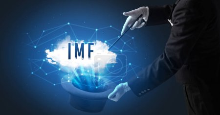 Magician is showing magic trick with IMF abbreviation, modern tech concept
