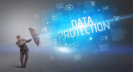 Foto de Empresario defendiendo con paraguas de ataque cibernético e inscripción PROTECCIÓN DE DATOS, concepto de seguridad en línea - Imagen libre de derechos