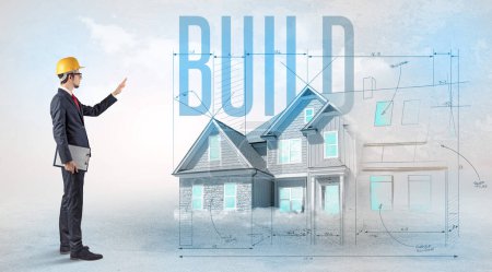 Photo for Young engineer holding blueprint with BUILD inscription, house planning concept - Royalty Free Image