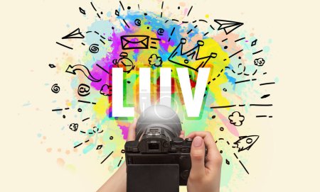 Close-up of a hand holding digital camera with abstract drawing and LUV inscription
