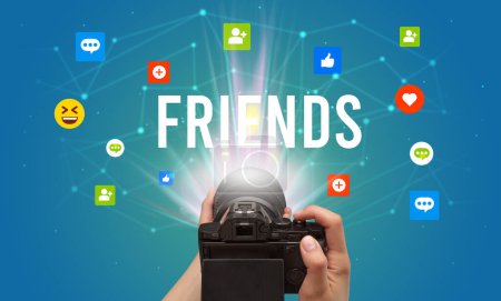 Téléchargez les photos : Utiliser la caméra pour capturer du contenu de médias sociaux avec l'inscription FRIENDS, concept de contenu de médias sociaux - en image libre de droit